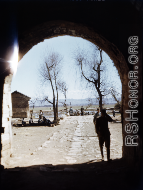 View out from a town gate in Yunnan, China, during WWII.