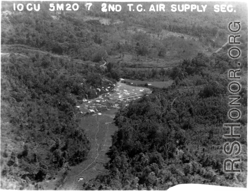 IOGU 5M20 7 2ND T.C. AIR SUPPLY SEC. Parachutes plaster a small area of open rice paddy.