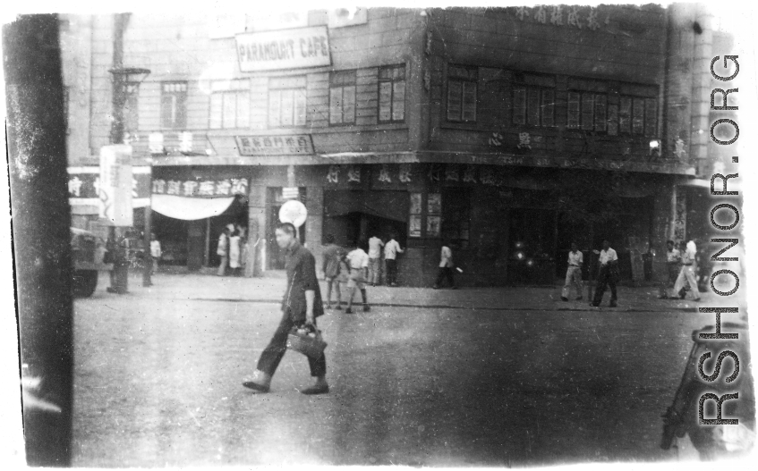 Street scene in China, with the Paramount Cafe in the background. During WWII.