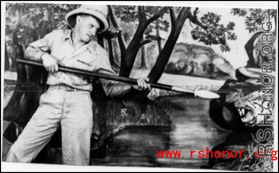 A GI pretends to fight a tiger in a fake forest in a studio in the CBI during WWII.