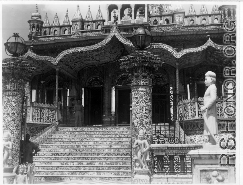GI visiting ornate temple.  Scenes in India witnessed by American GIs during WWII. For many Americans of that era, with their limited experience traveling, the everyday sights and sounds overseas were new, intriguing, and photo worthy.