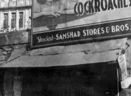 A shop with a large pesticide sign in India or Burma, during WWII.  In the CBI.