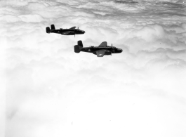 Two B-25Ds of the 491st Bm Sq fly above a solid cloud layer.  Running out of fuel because clouds hid the air fields caused more aircraft losses in China than did the enemy aircraft or anti-aircraft fire.