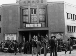 American GIs stand in front of market and and movie theater in Kunming, Yunnan province, China. During WWII.
