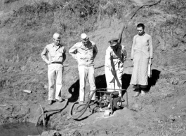 American and Chinese personnel pumping water near an American base, China, during WWII.  From the collection of Wozniak, combat photographer for the 491st Bomb Squadron, in the CBI.