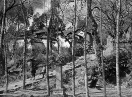 Local people in a village in Yunnan province, China: A walk way up the hill in a small village, with a small commemorative stone erected near by.
