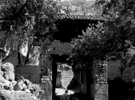 A village passageway through a village gate in Yunnan province, China. During WWII.