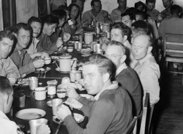 GIs eating nice meal in club house or nice mess hall in Yunnan, China, during WWII.
