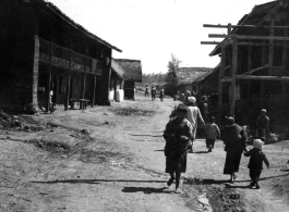 People go about lives in small township in China during WWII.