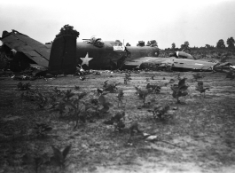 Wrecked B-25 Mitchell bomber on the ground in the CBI. The wreck was apparently at an air base, and probably on take-off, as the craft is sprayed with fire-retardant foam, and bombs are scattered about the wreck site. During WWII.