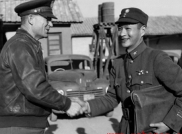 Chinese and American officers shake hands in SW China during WWII.