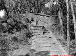 Kids run on a village path at a village near Yangkai, Yunnan province, China, during WWII.