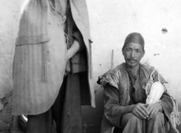 Local people in Yunnan province, China, during WWII.  The man on the left is wearing typical clothing of the Yi ethnic group.  From the collection of Eugene T. Wozniak.