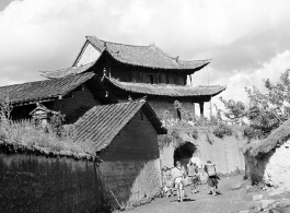 Local people in China: People go through village gate.  From the collection of Eugene T. Wozniak.
