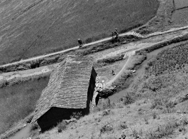 An apparent mill house over a canal, and farmers walking path, in Yunnan province, China, during WWII.  From the collection of Eugene T. Wozniak.