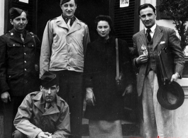 An elite Chinese woman poses with American servicemen and local people in Yunnan province, China, during WWII. 
