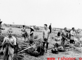 Roadside vendors sell vegetables in China during WWII.