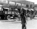 Street in India or Burma, with GIs riding rickshaws. During WWII.