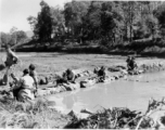 Local people wash clothes. Probably at Yangkai, China. During WWII.