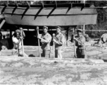 Wranging logs towards saw with cant hooks at a lumber mill of the 797th Engineer Forestry Company in Burma.  During WWII.