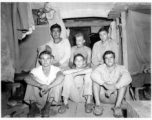 Engineers of the 797th Engineer Forestry Company pose in their barracks in Burma.  During WWII.