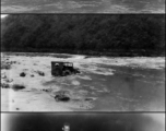 GIs salvaging precious fuel that had fallen into the stream. 