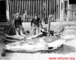 American and Chinese soldiers look over remains of a crashed Japanese airplane in the CBI during WWII.