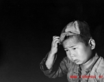Local people in China during WWII: A Chinese child wearing a cap.