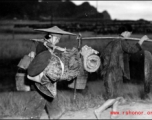Refugees carry possession while fleeing around either Liuzhou or Guilin during the evacuation before the Japanese Ichigo advance in 1944, in Guangxi province.