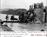 Chinese troops cross walkway (actually a long flat bottom boat) above water en route to Burma-China border front lines of the Salween River Campaign in 1944.  Photo from T/Sgt. Syd Greenberg.