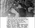 803rd MAES and 2nd TCS evacuating combat casualties on the first evacuation for the 803rd. Litter patients are: Pilot Capt. Walter Eschwald and Co-pilot F. O. Capt. Ivan Hirshburg.  Flight nurse Lt. Audrey Rodgers, chief nurse of the 803rd MAES, Capt. Duncan, medical officer, 803rd. Capt Carey Leggett, medical officer for 2nd TCS. At door, Sgt. Harrison Vickers, 2nd TCS medic with gun at this waist.  Photo from R. A. Satterfield.