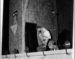 Cross-dressing GI removes an article of clothing while the band Jive-o-Lieps plays music in the CBI during WWII. 54th Air Service Group.