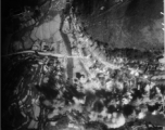 In these remarkable two images, we see a small town in Guangxi Province, SW China, being bombed by American B-25 bombers. In the upper image, just seconds before the bombs hit, one can see the streets filled tightly with trucks of a convoy, with many people milling or running about. This is during the  Japanese 'Ichigo' push of summer or fall 1944. The crowds are especially large and dense for the time.