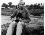 GI holding a dog in Yunnan province, China.